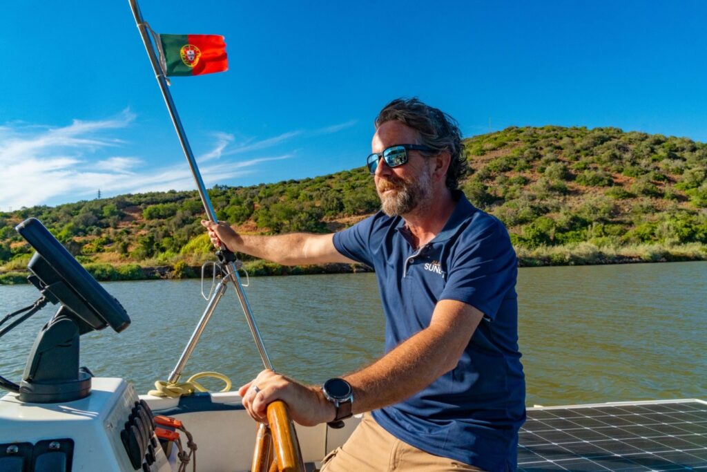 Captain Pedro steers the Sunboat